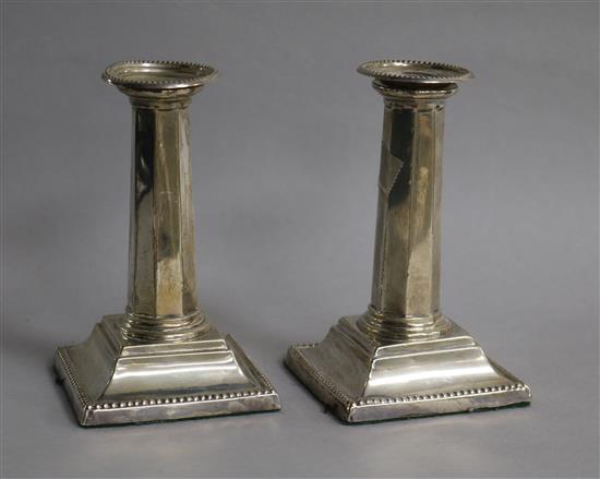 A pair of Edwardian silver candlesticks, with panelled stems, Ellis Jacob Greenberg, Birmingham, 1907, 13.2cm.
